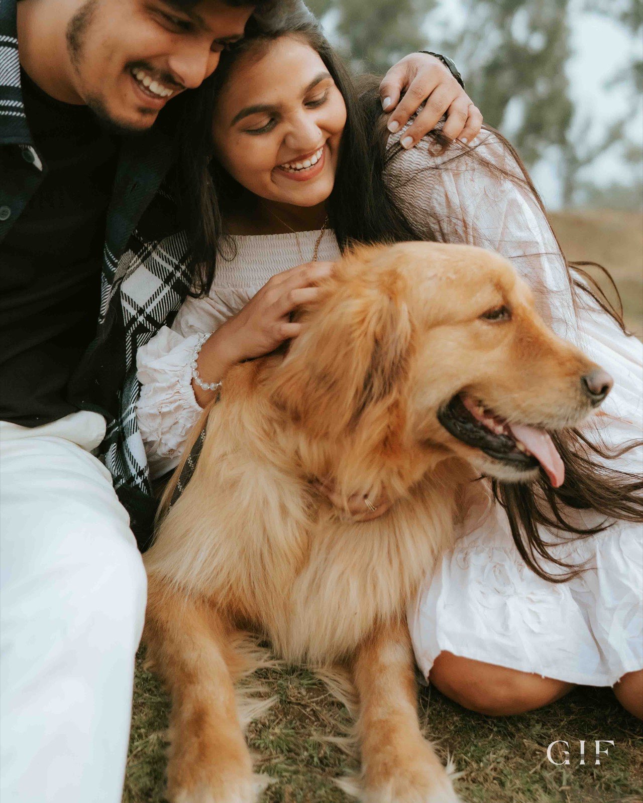 Shivam and Samruddhi cuddling their golden retriever
