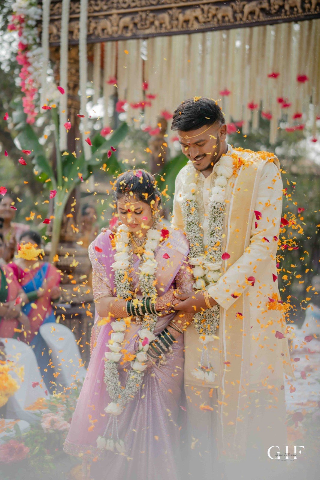 Shreya and Neelesh surrounded by falling flower petals